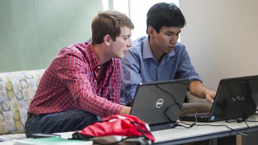 Students looking at laptop.