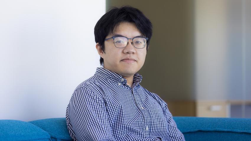 man sitting on blue couch